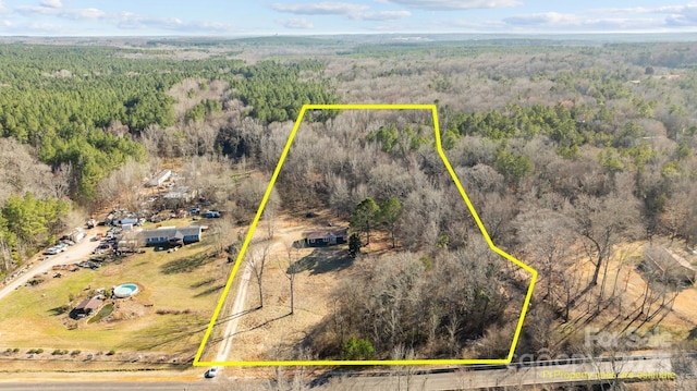 aerial view featuring a wooded view