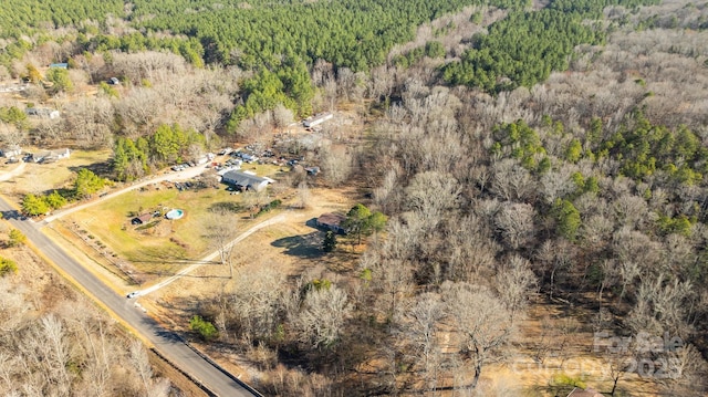 birds eye view of property with a view of trees