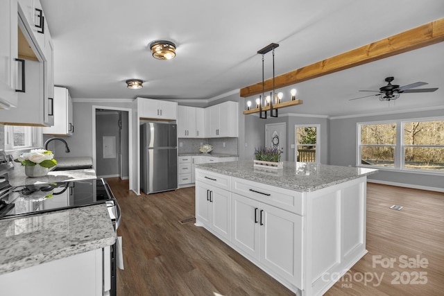 kitchen with dark wood-style floors, electric stove, decorative backsplash, ornamental molding, and freestanding refrigerator