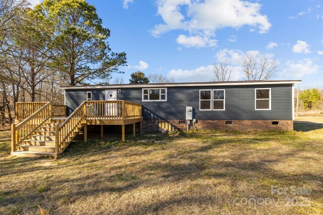 back of property featuring stairway, crawl space, a yard, and a deck