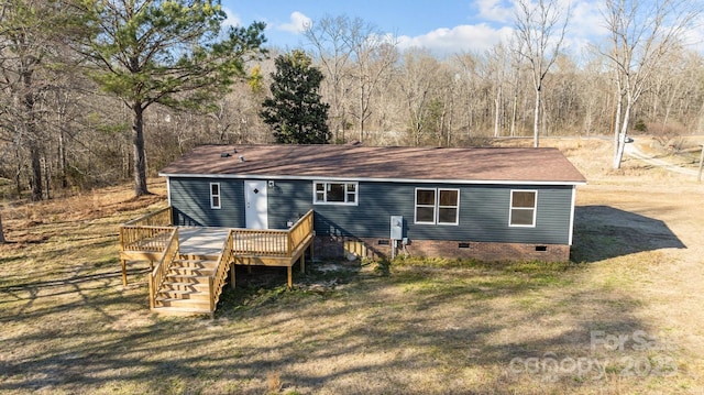 rear view of house with crawl space, a yard, a wooden deck, and stairs