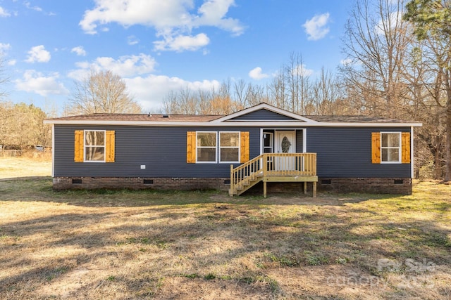 manufactured / mobile home with a front lawn and crawl space