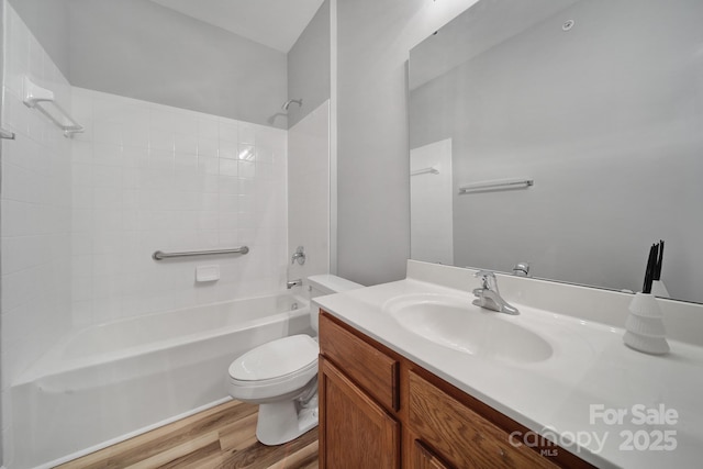 full bathroom with tub / shower combination, vanity, toilet, and wood finished floors