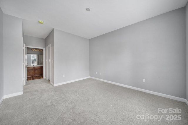 unfurnished bedroom with light carpet and baseboards