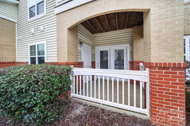 view of exterior entry with brick siding