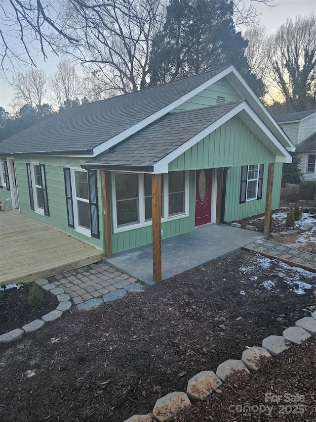 view of front of property with a shingled roof and board and batten siding