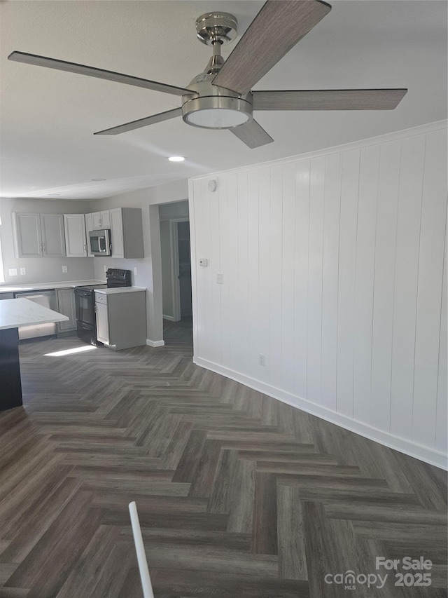 unfurnished living room with ceiling fan