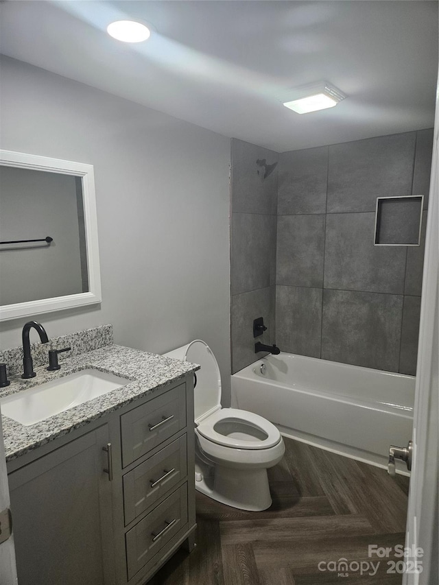 bathroom with shower / bath combination, vanity, and toilet