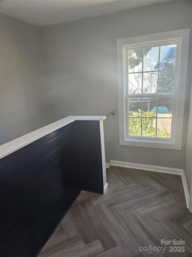 staircase featuring baseboards and a healthy amount of sunlight