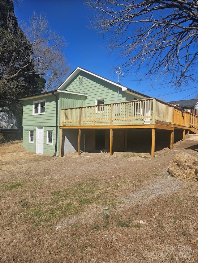 rear view of house featuring a deck