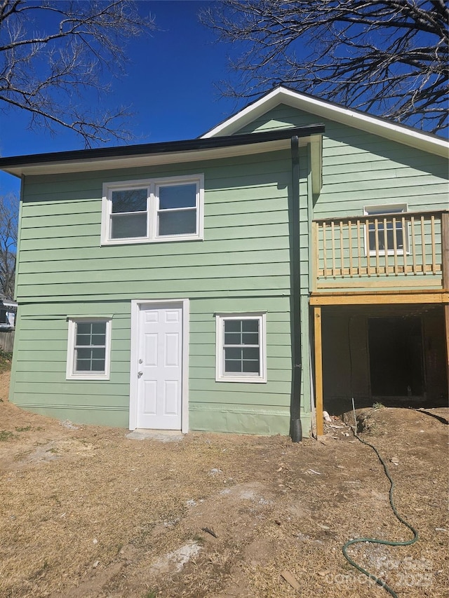 back of property with a wooden deck