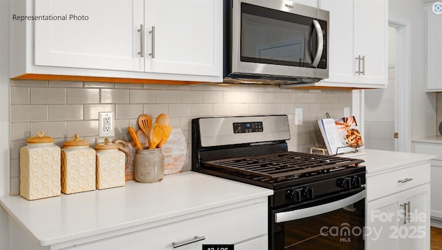 kitchen featuring light countertops, appliances with stainless steel finishes, decorative backsplash, and white cabinets