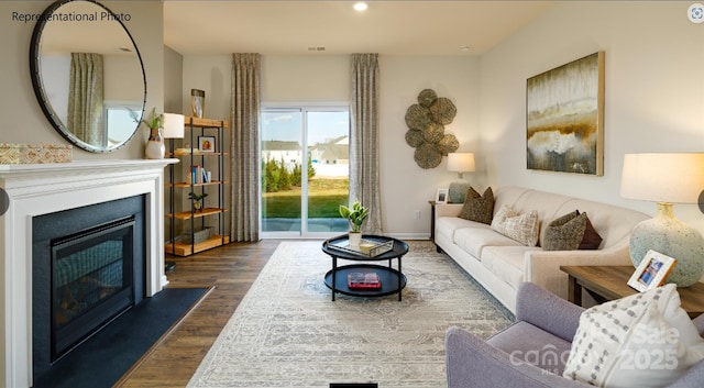 living room with dark wood-style flooring, recessed lighting, visible vents, a glass covered fireplace, and baseboards