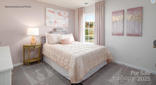 carpeted bedroom featuring visible vents and baseboards