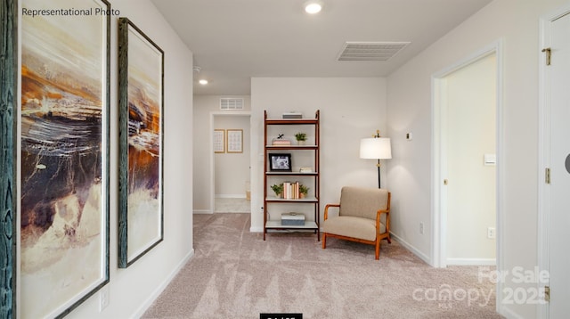 sitting room featuring light colored carpet, visible vents, baseboards, and recessed lighting