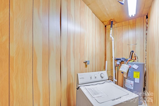 laundry room featuring wood walls, laundry area, washer / clothes dryer, and electric water heater