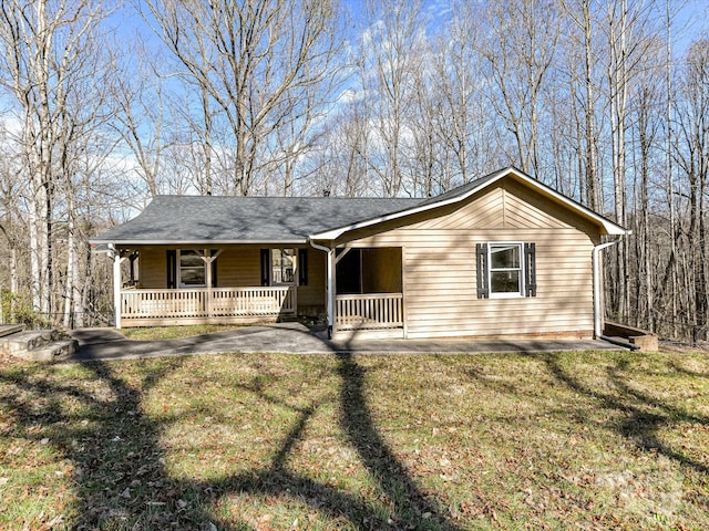 ranch-style home with a porch and a front yard