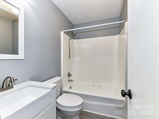 full bathroom with shower / tub combination, a textured ceiling, toilet, and vanity