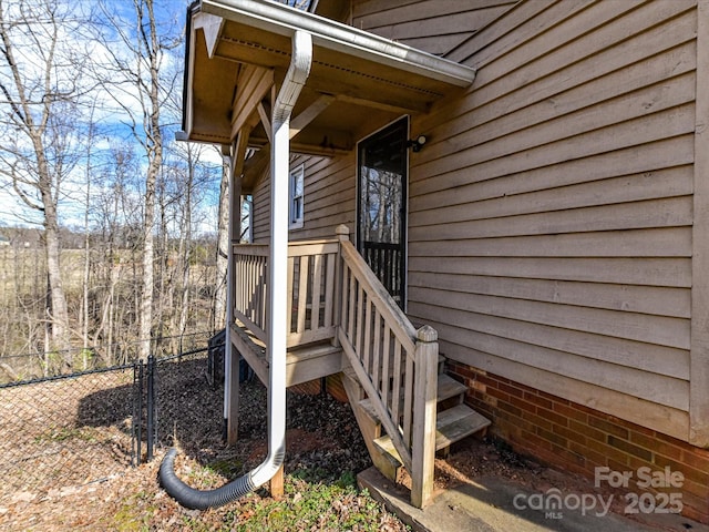 view of exterior entry featuring fence