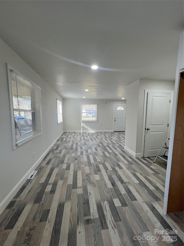 below grade area featuring baseboards and wood finished floors