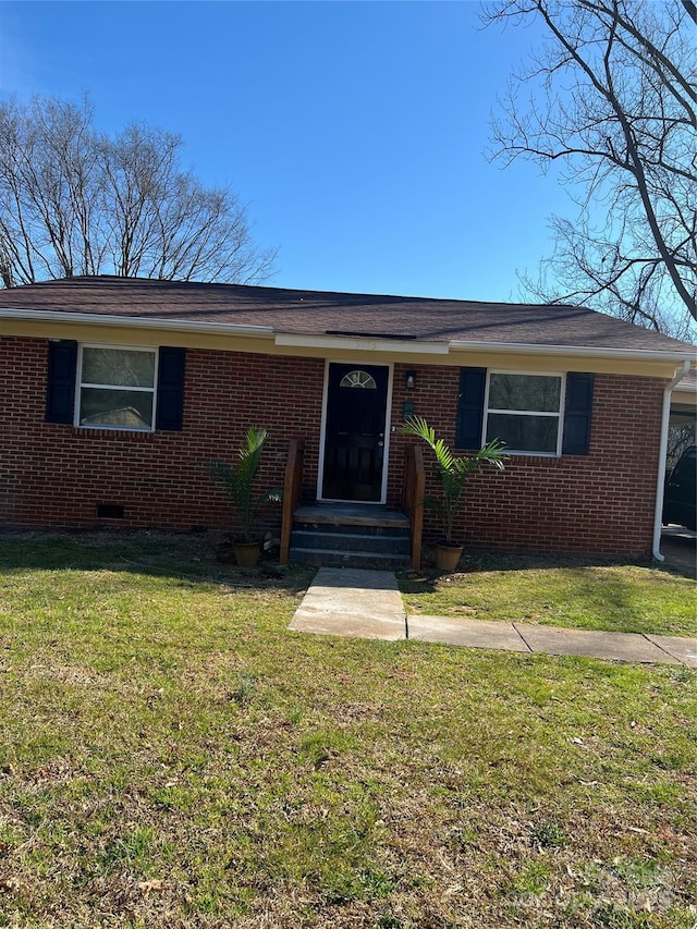 ranch-style home with brick siding, crawl space, and a front yard