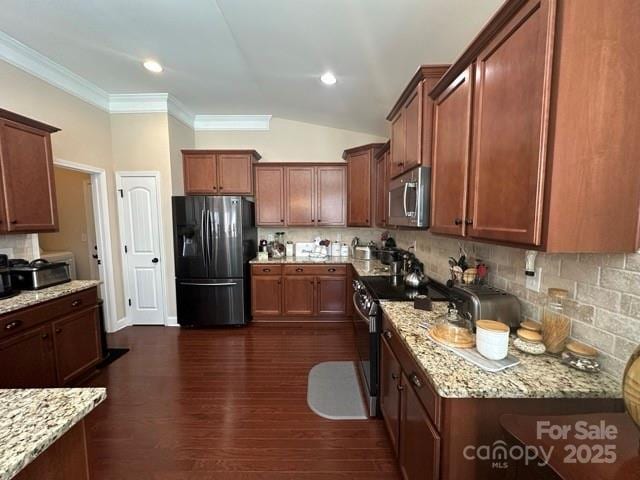 kitchen featuring stainless steel appliances, decorative backsplash, light stone counters, and dark wood-style floors