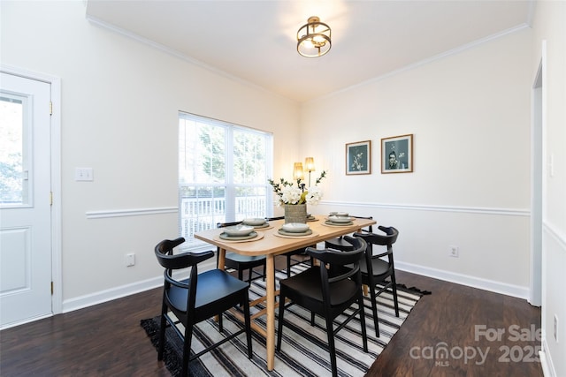 dining space featuring crown molding, baseboards, and dark wood-style flooring