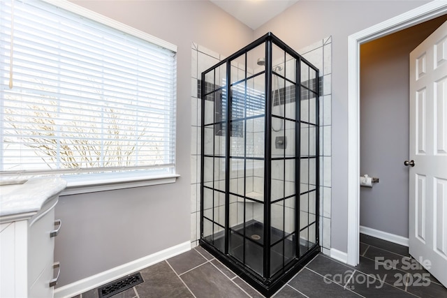 bathroom featuring tile patterned flooring, visible vents, and baseboards