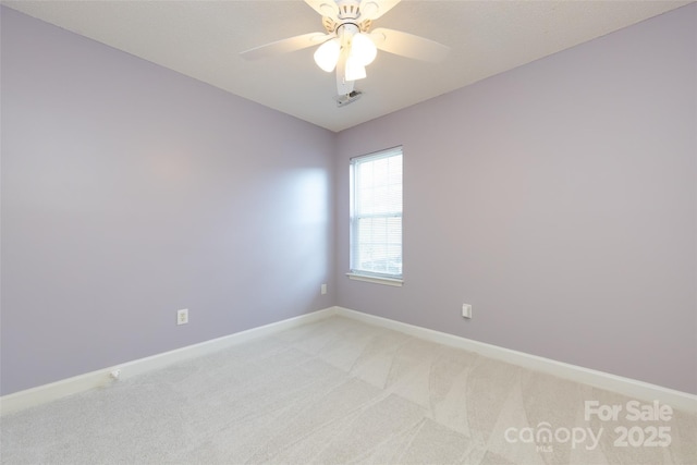 unfurnished room featuring light carpet, ceiling fan, and baseboards