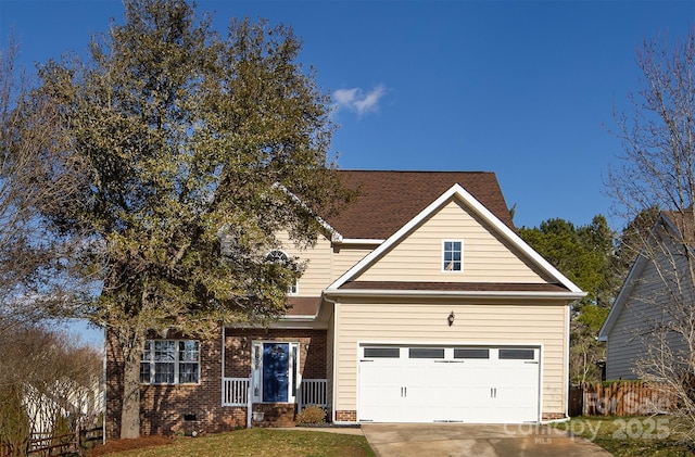 traditional-style house featuring an attached garage, brick siding, fence, concrete driveway, and crawl space