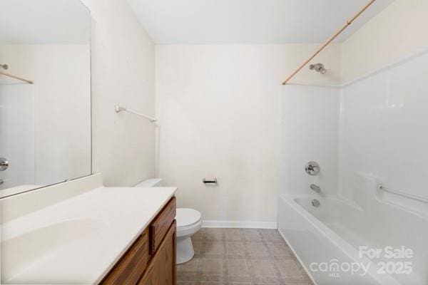 bathroom featuring washtub / shower combination, baseboards, vanity, and toilet