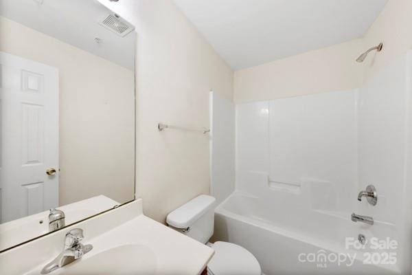 bathroom with toilet,  shower combination, vanity, and visible vents