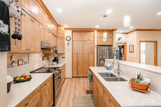 kitchen featuring ornamental molding, appliances with stainless steel finishes, under cabinet range hood, a sink, and light wood-style floors