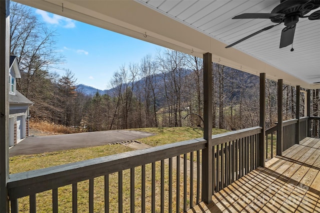 wooden terrace with a yard and a ceiling fan