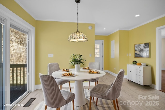 dining area featuring light tile patterned floors, baseboards, visible vents, and ornamental molding