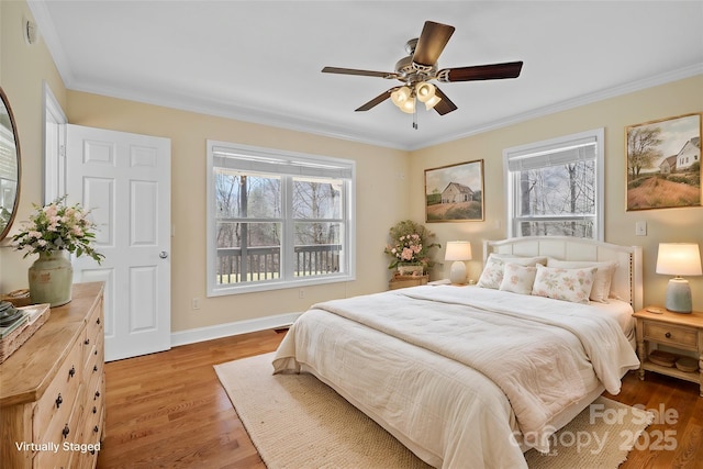 bedroom with ornamental molding, light wood finished floors, multiple windows, and baseboards