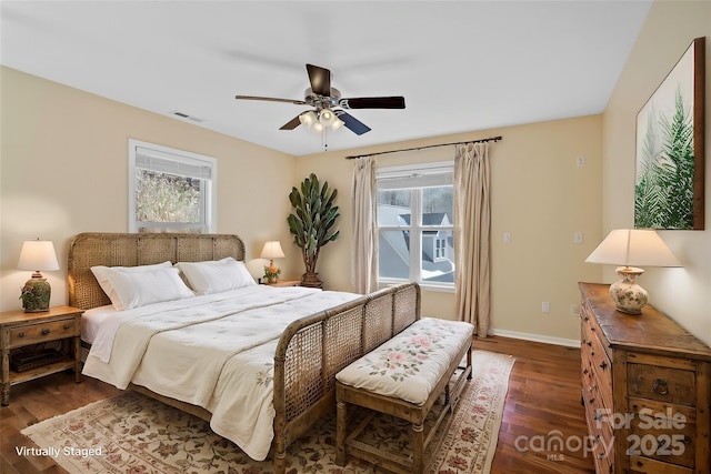 bedroom with a ceiling fan, dark wood finished floors, visible vents, and baseboards