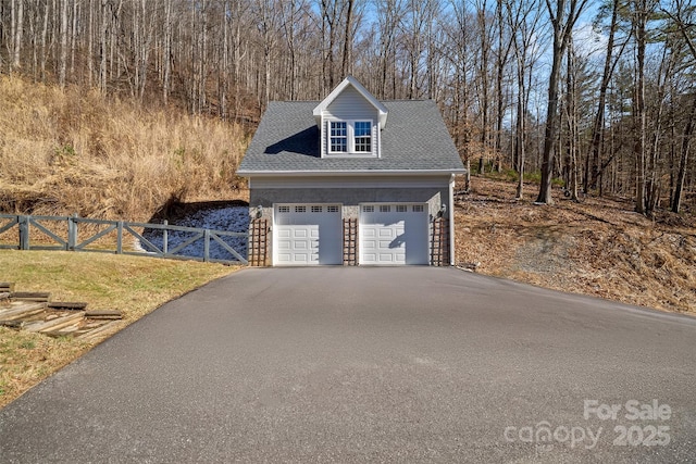 garage with a garage and fence