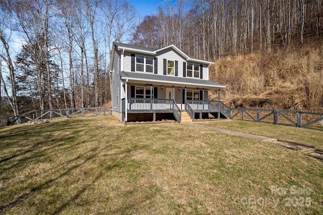 view of front of house with covered porch, a front lawn, and a fenced backyard