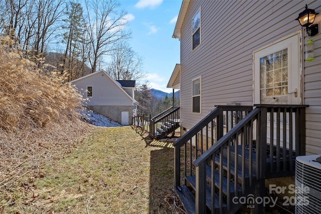 view of yard with a mountain view, stairway, and central air condition unit