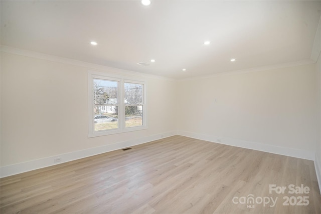 unfurnished room with light wood-type flooring, baseboards, and ornamental molding