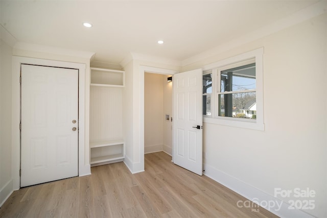 interior space with recessed lighting, baseboards, light wood-style floors, a closet, and crown molding