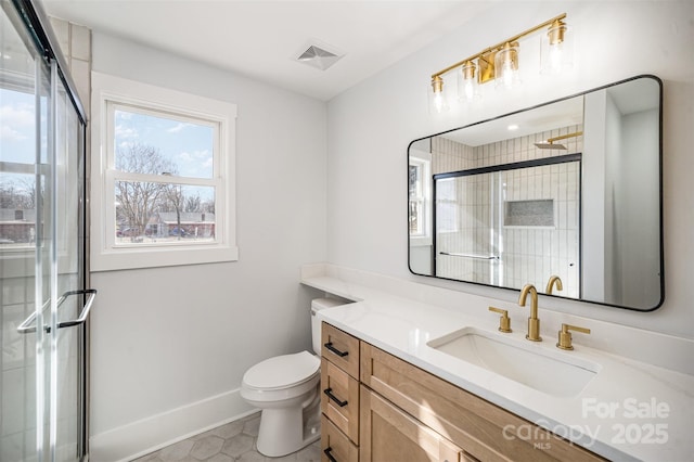 full bathroom featuring a stall shower, baseboards, visible vents, toilet, and vanity