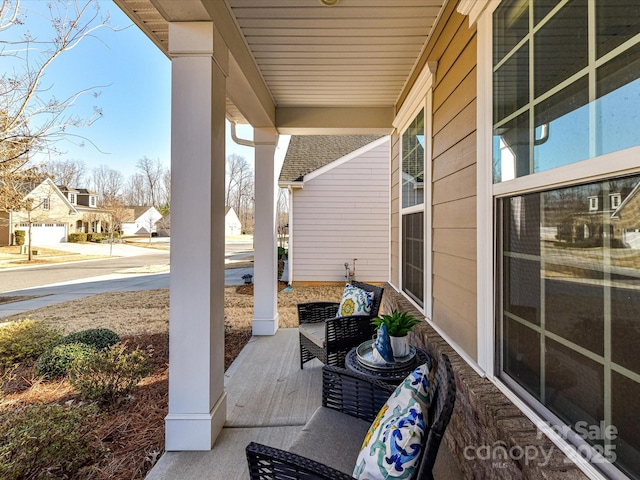 view of patio / terrace featuring covered porch and a residential view