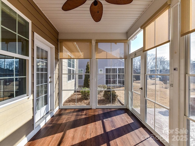 unfurnished sunroom featuring ceiling fan