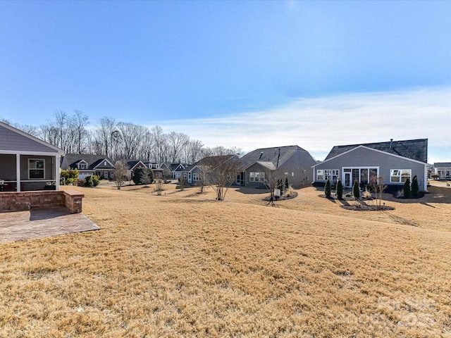 view of yard with a residential view and a patio area