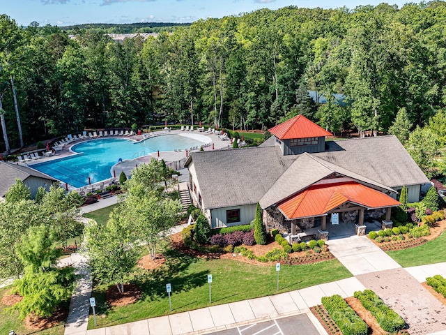 birds eye view of property with a forest view