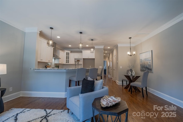 living area featuring recessed lighting, dark wood-type flooring, baseboards, ornamental molding, and an inviting chandelier