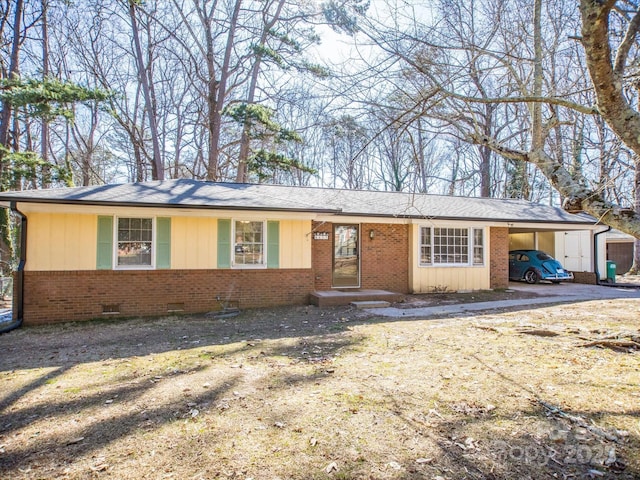 single story home with crawl space, a shingled roof, an attached carport, and brick siding