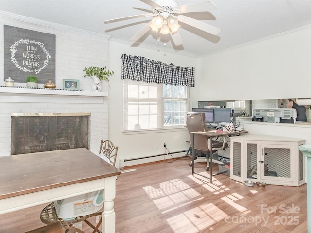 office area featuring a ceiling fan, ornamental molding, wood finished floors, a fireplace, and a baseboard heating unit